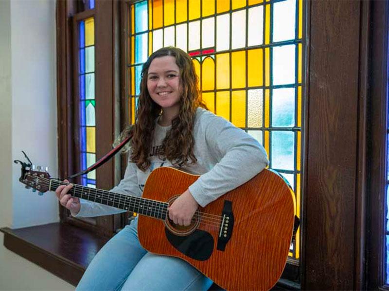 Young woman playing a guitar